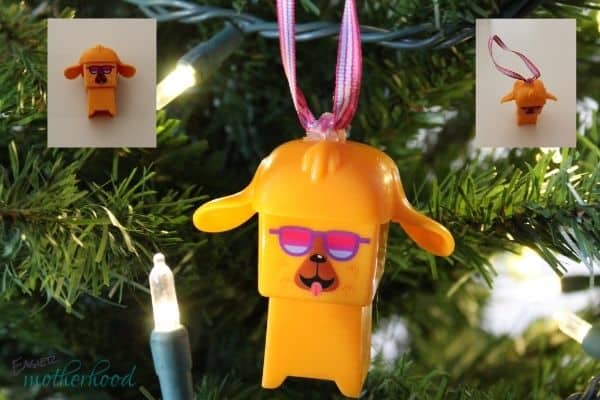 An orange block toy turned into a Christmas ornament with a Christmas Hack of using ribbon and hot glue