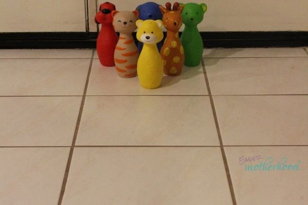 Animal Bowling Pins set up and ready for a toddler to knock down, one of the featured fun and easy indoor preschool activities.