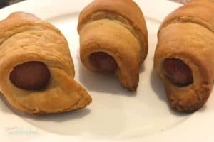 Hot dogs wrapped in crescent rolls and baked- aka pigs in a blanket, an easy and kid friendly lunch idea.