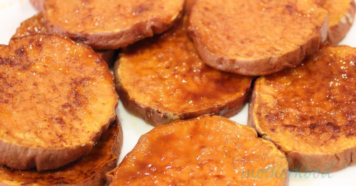 Photo of roasted sweet potato slices on a white plate.