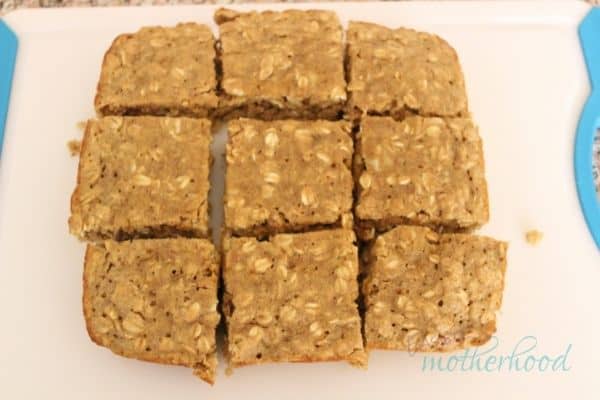 Finished peanut butter and banana oat bars on cutting board cut into 9 squares
