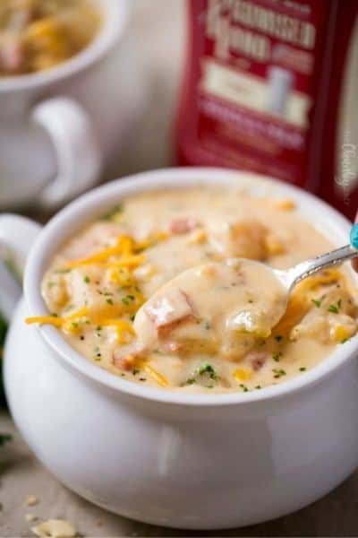 Slow Cooker Cheesy Ham Chowder in a bowl with handles