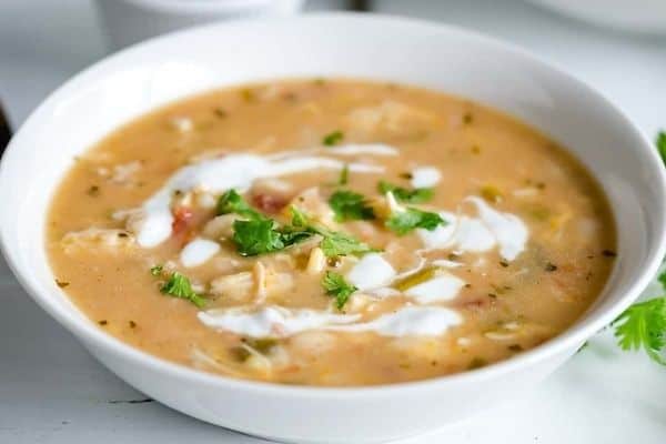 A white bowl filled with crockpot white chicken chili