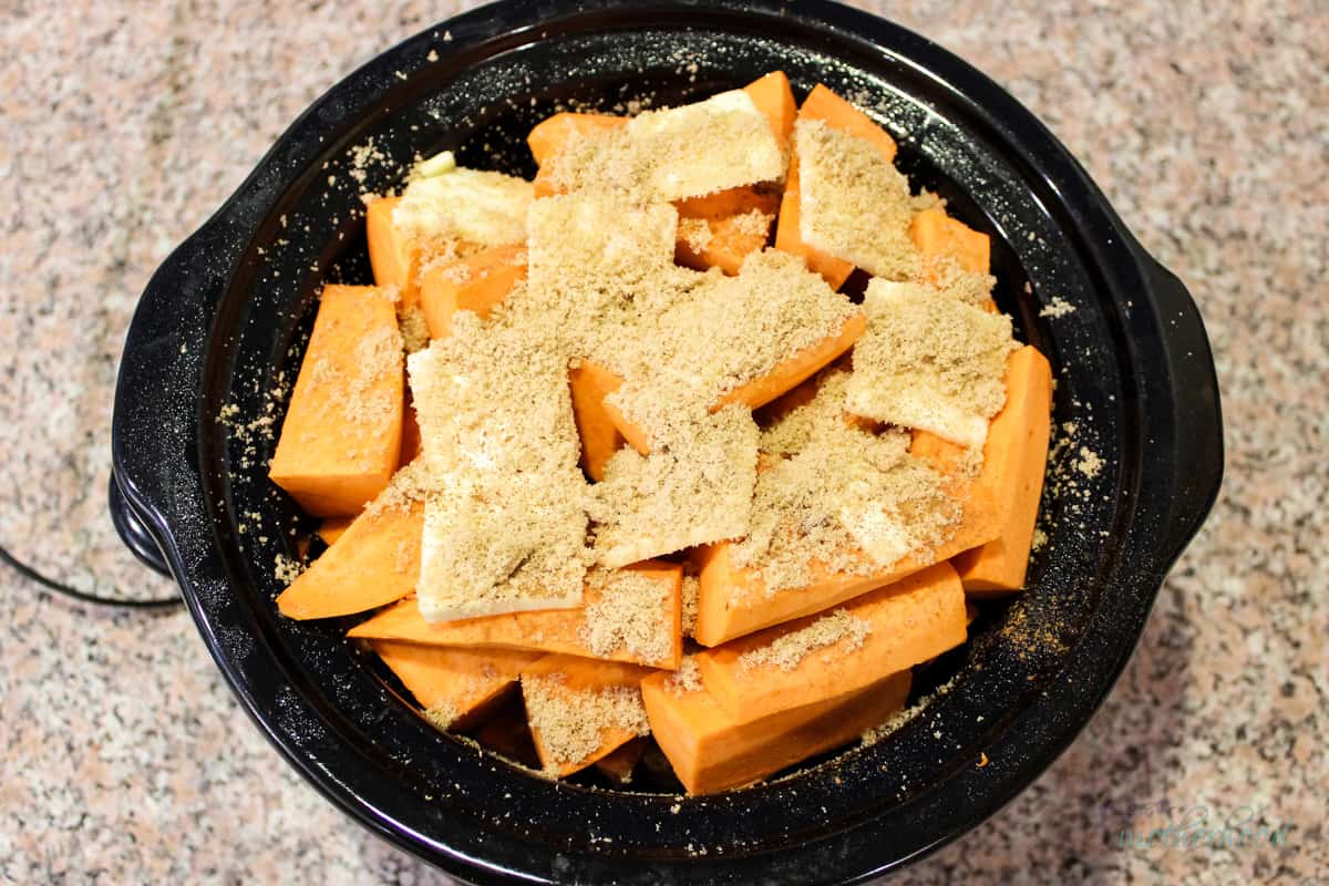 Ready to cook layered sweet potato chunks, butter, sugar, and spices. 