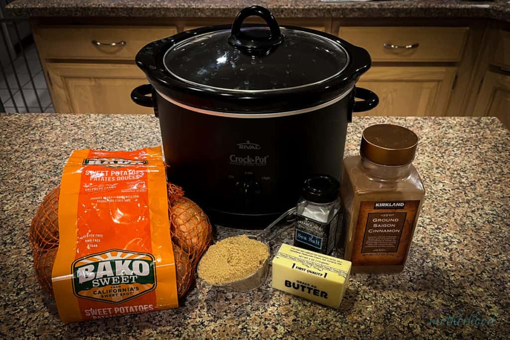 Ingredients photo showing crock pot, sweet potatoes, cinnamon, brown sugar, and butter sitting on a kitchen counter.