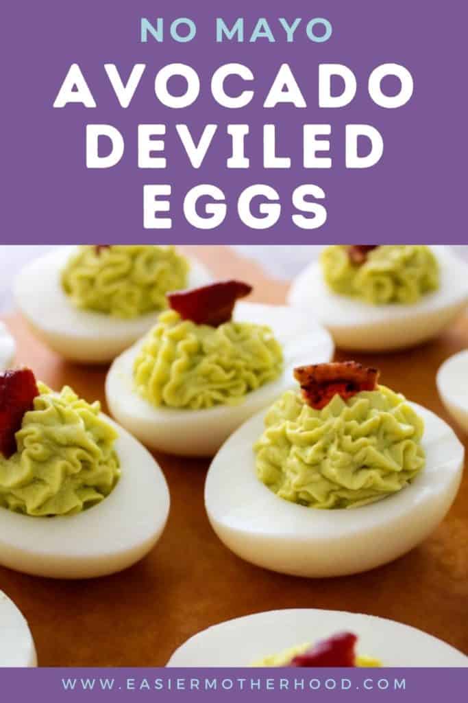 Pin image of avocado deviled eggs garnished with bacon. Text above reads "no mayo avocado deviled eggs".
