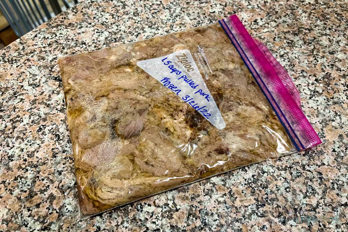 Labeled quart bag of leftover pulled pork on counter