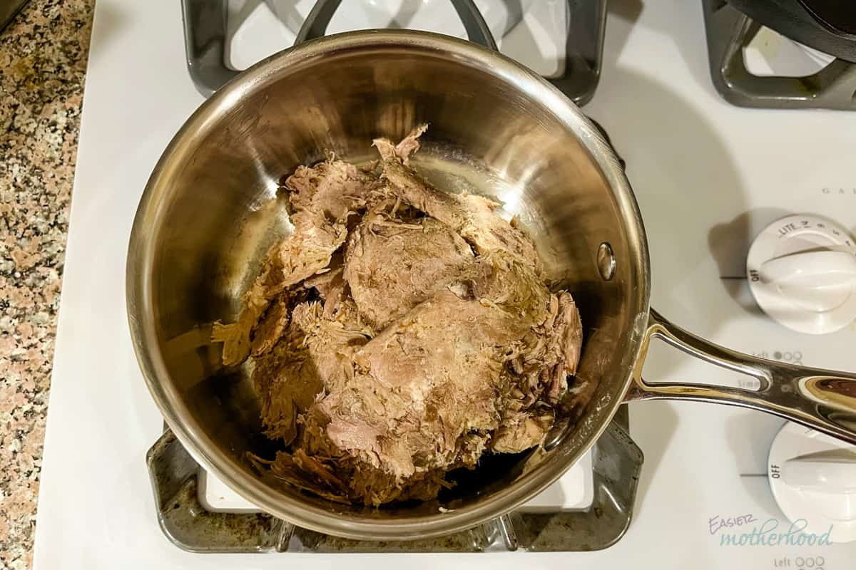 Thawed pork in small saucepan on stove