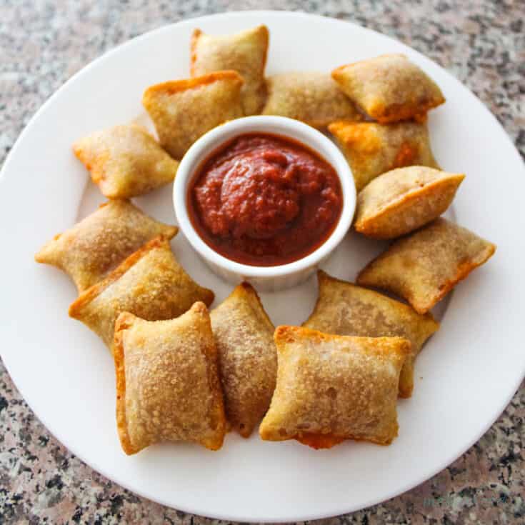 Pizza Rolls after Air Frying on a white plate with a side of pizza sauce