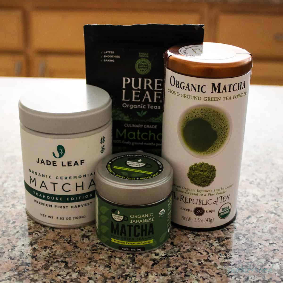 4 different brands of matcha on a counter, 2 culinary and 2 ceremonial