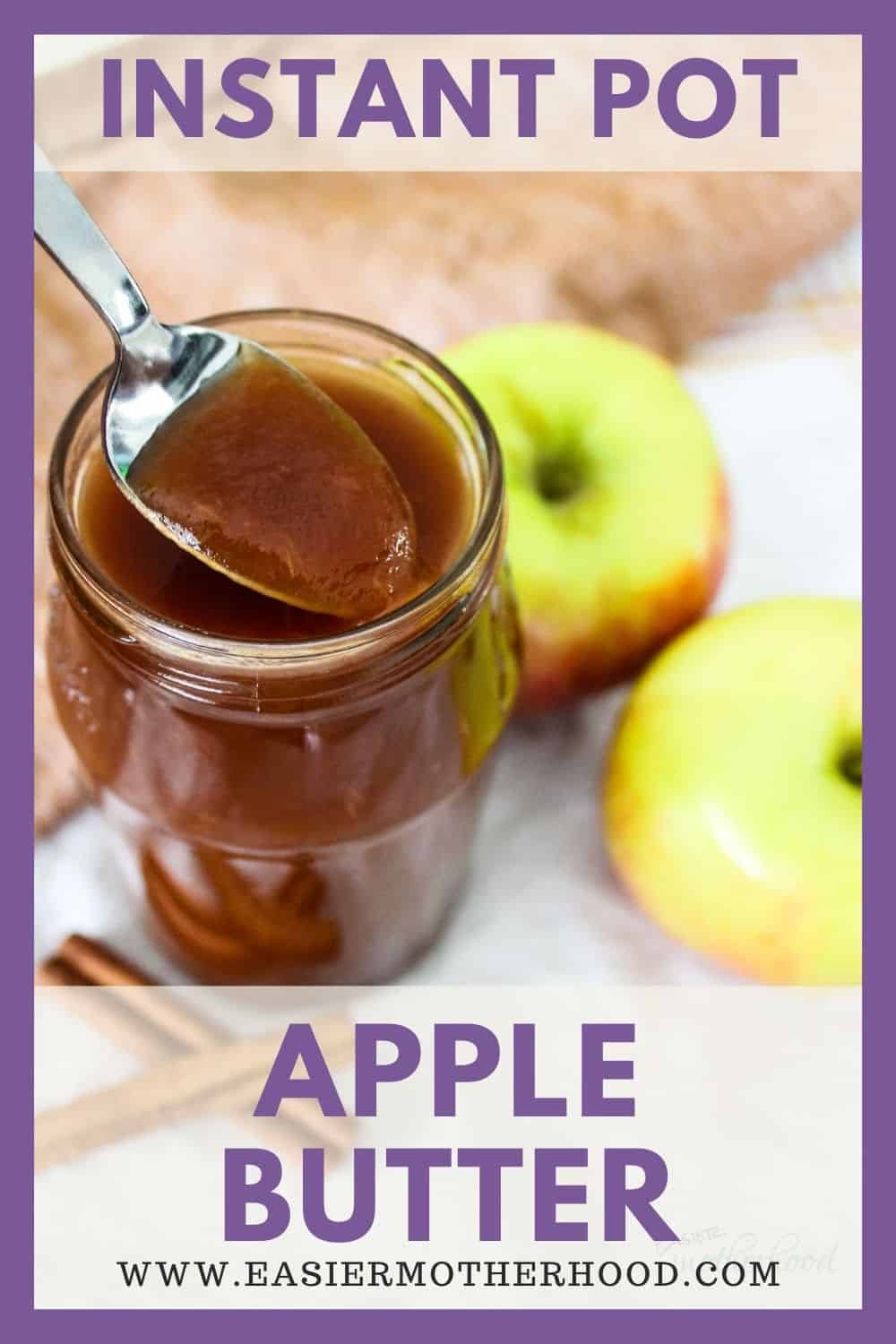 Apple butter being spooned out of jar with apples and cinnamon in background