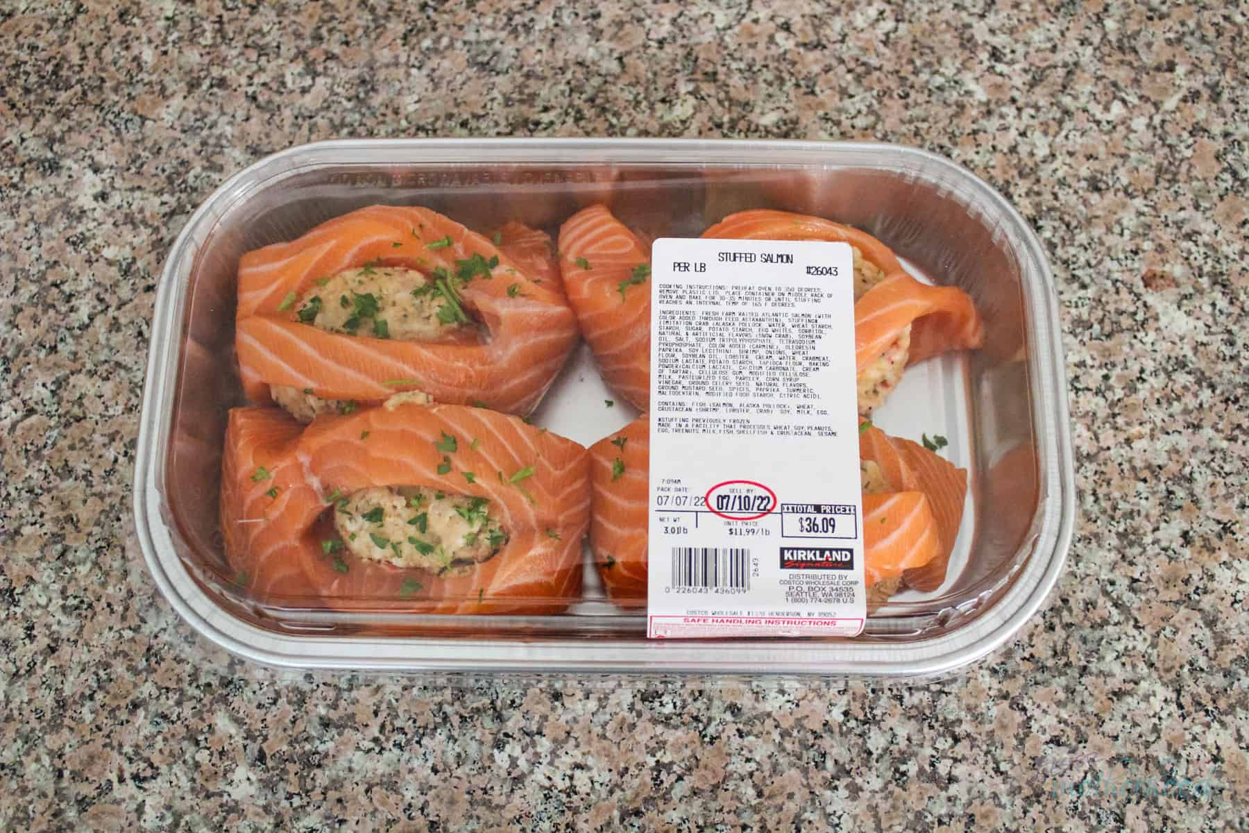 Container of Costco Stuffed Salmon on counter with lid on