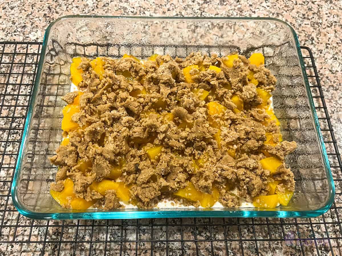 Baking pan with crumble topping added, ready for the oven.