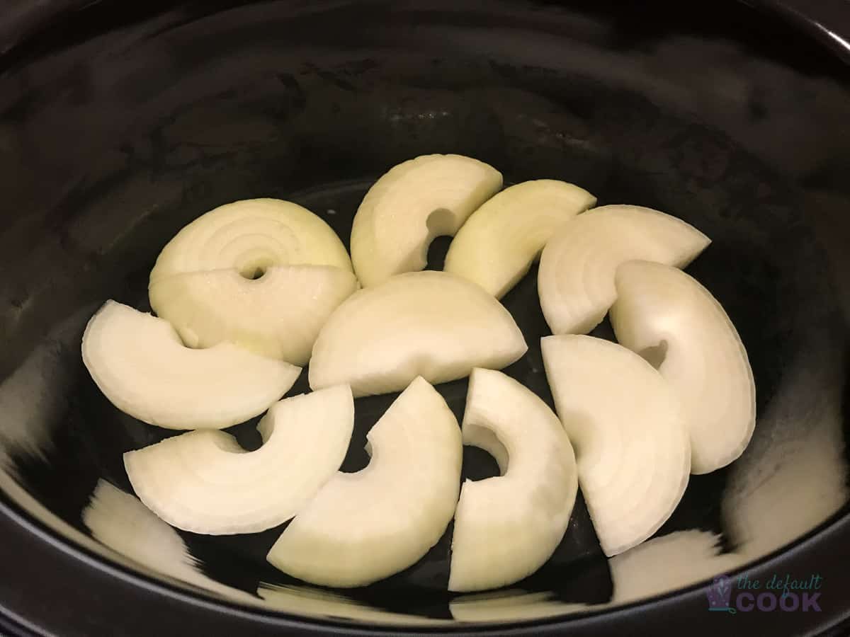 Crock pot with bed of onions in it