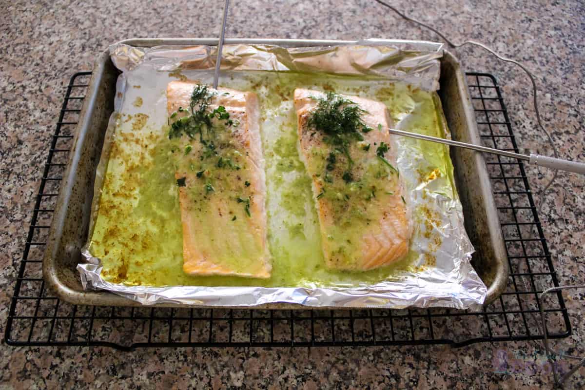 Oven cooked salmon milano on a lined baking tray.