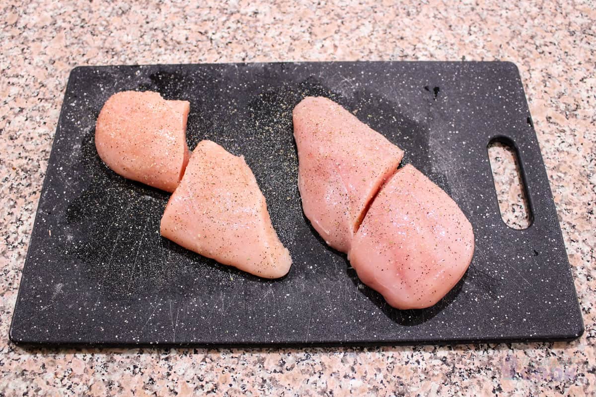 Seasoned chicken breasts cut in half.