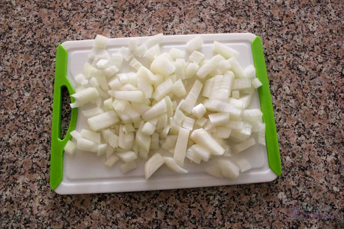 Diced white onion on cutting board.