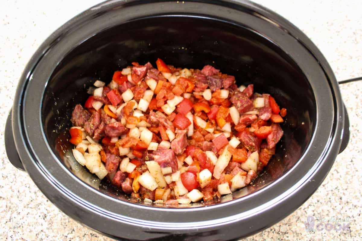 Raw ingredients in slow cooker after stirring together.