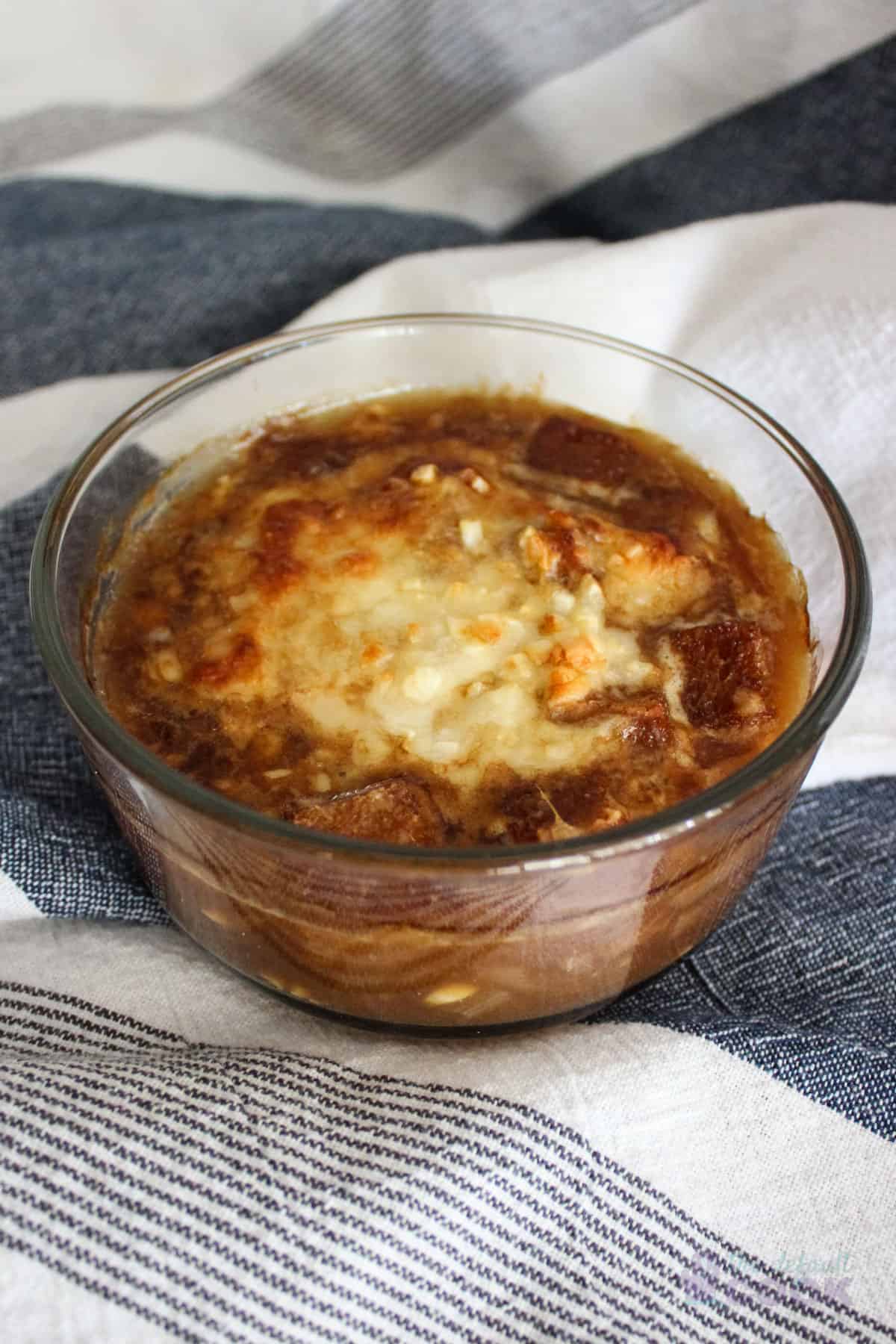 Bowl of Costco french onion soup on a kitchen towel.