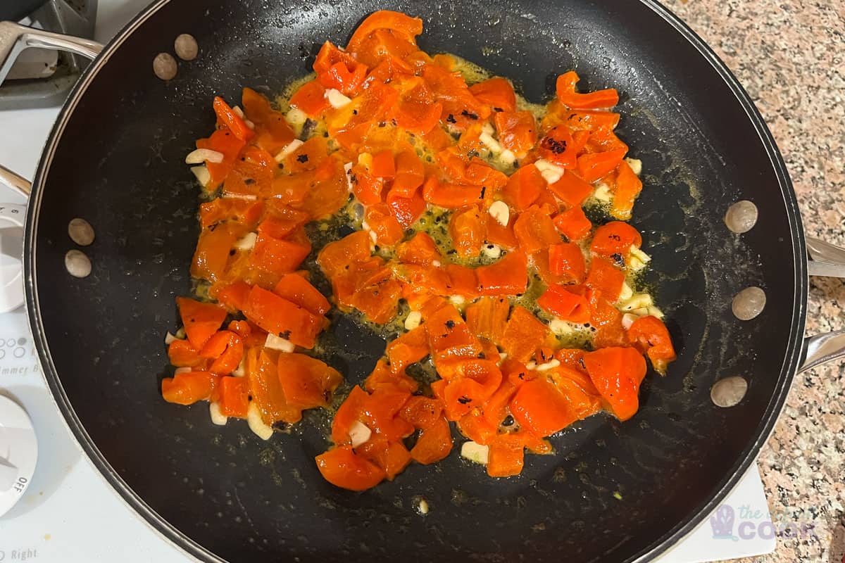 Skillet after cooking roasted peppers for 2 minutes.