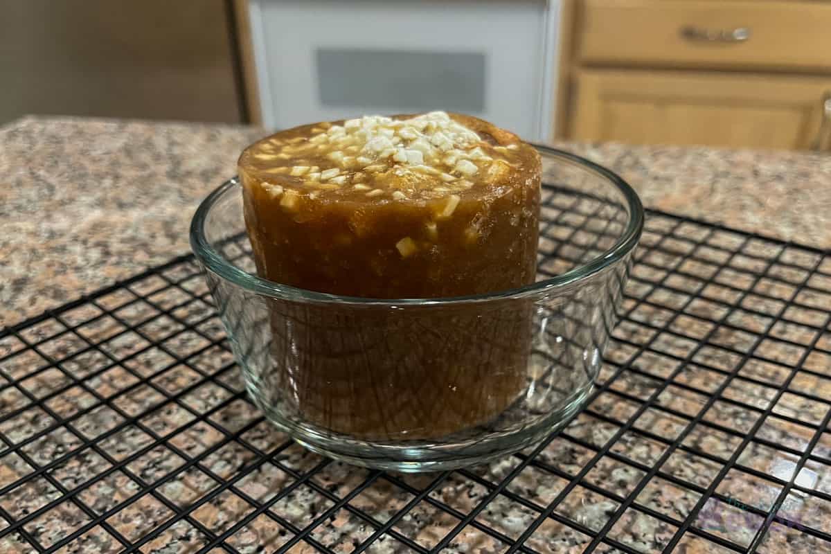 Frozen soup brick in 2 cup pyrex on kitchen counter.