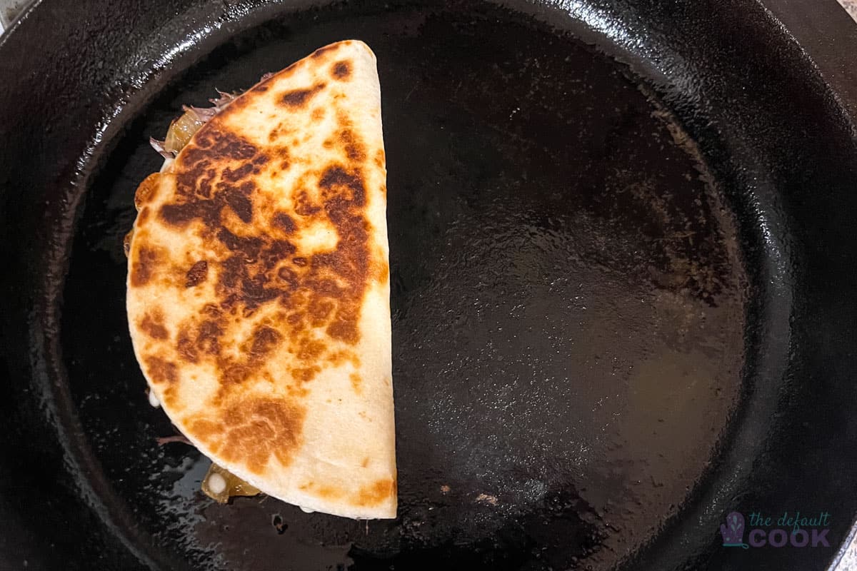 Quesadilla after flipping, with the second side finishing cooking.