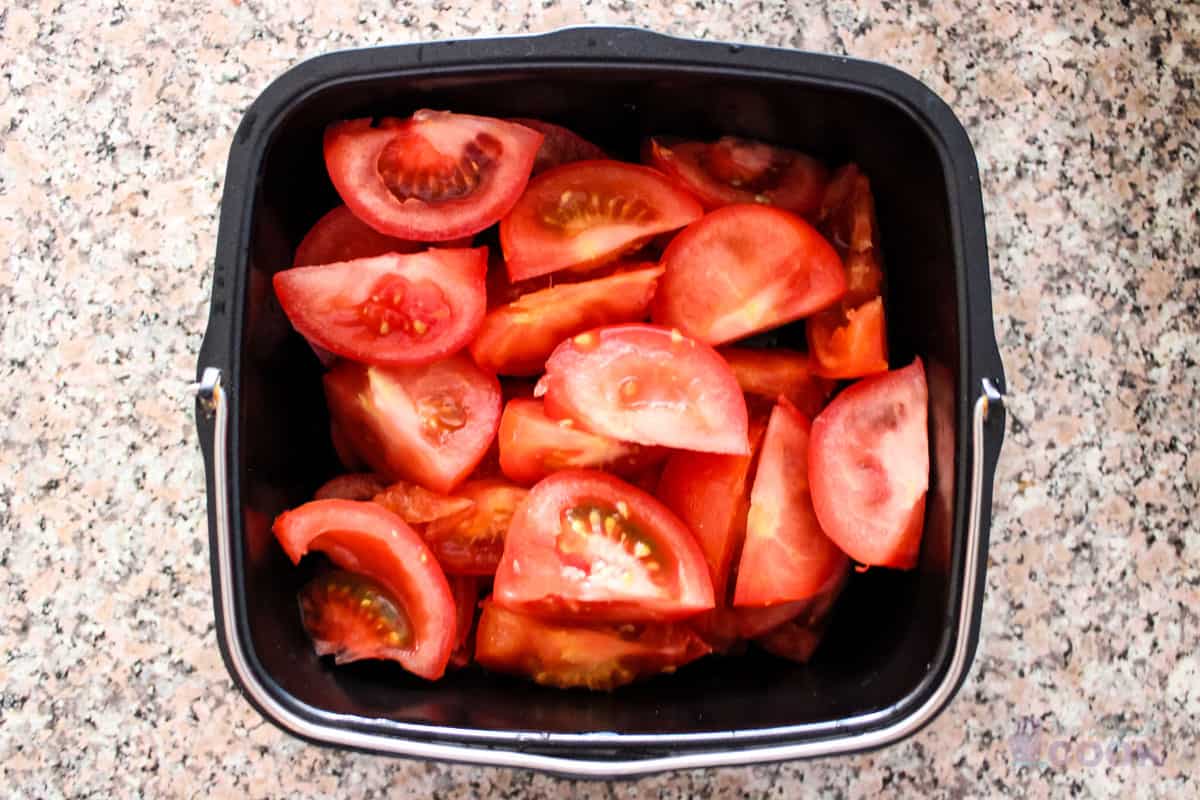 Tomatoes cut up and in baking dish.