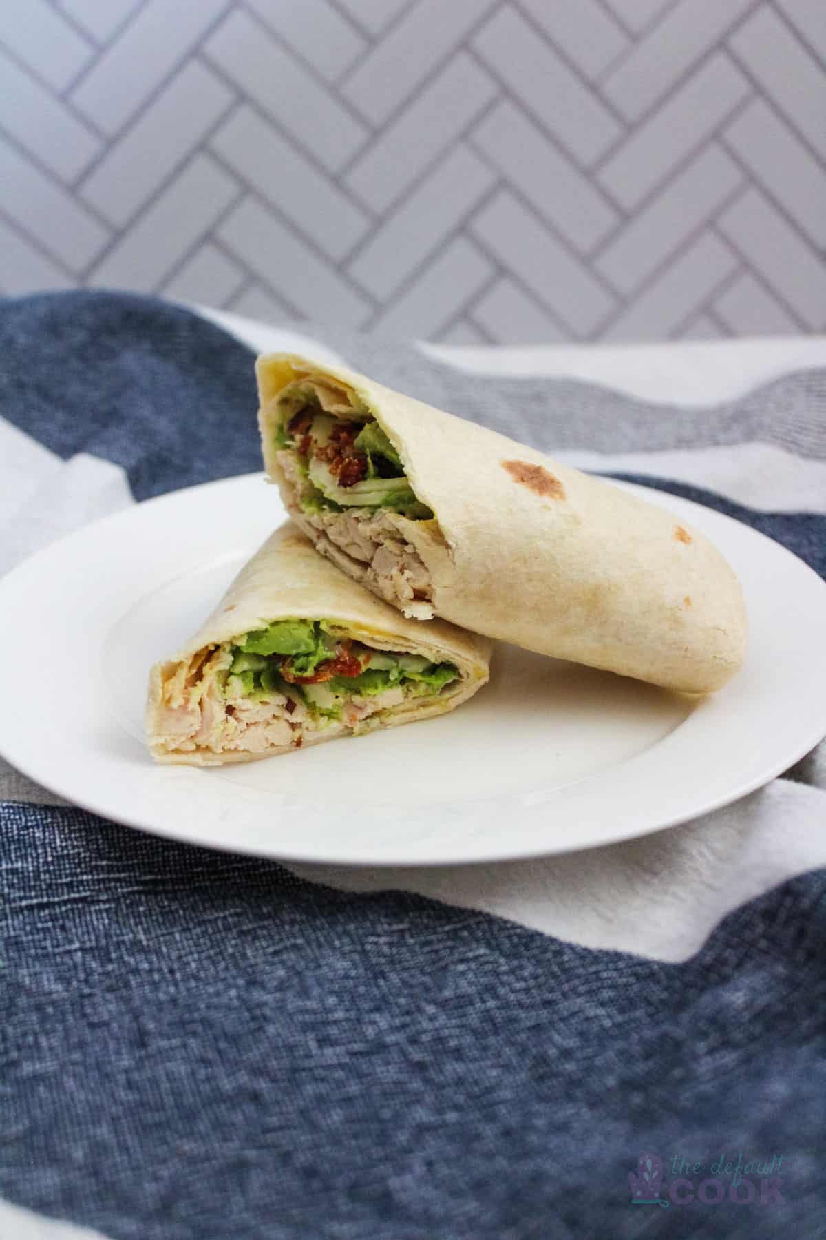 Two halves of a chicken wrap stacked on top of one another.