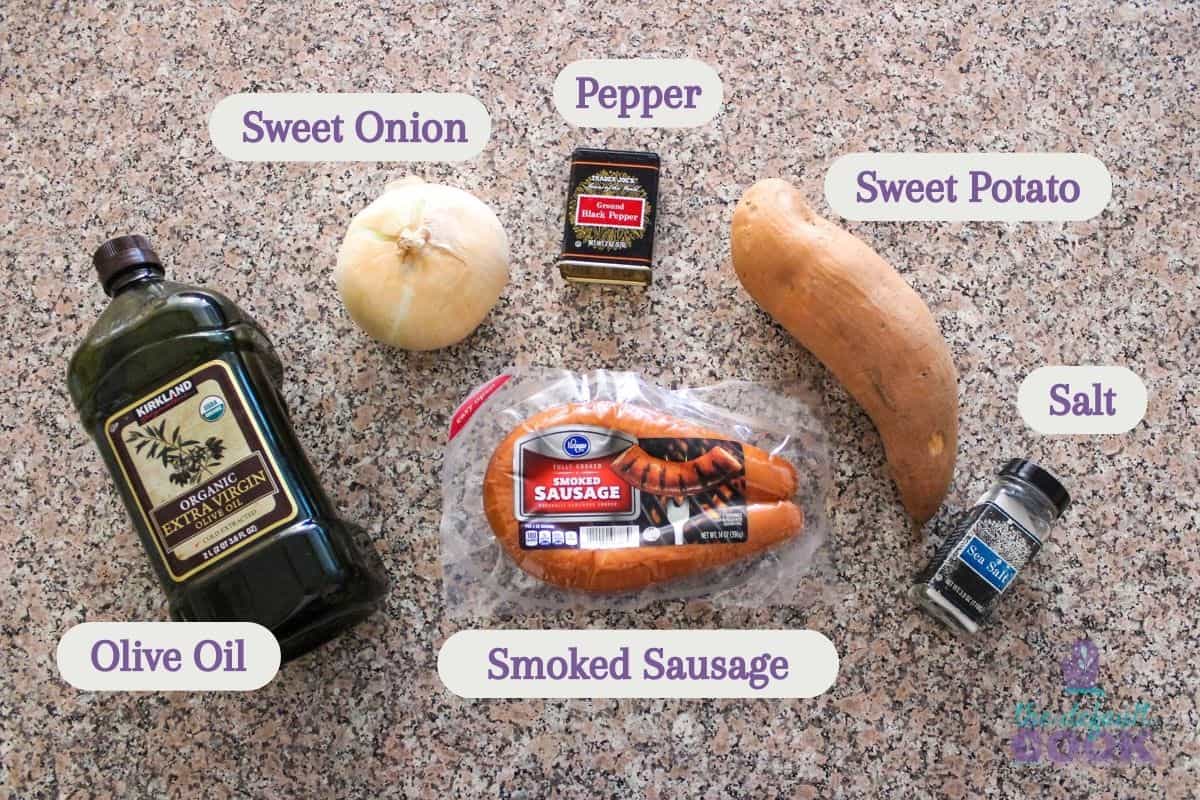 Labeled ingredients on a kitchen counter: oil, onion, salt, pepper, sausage, and sweet potato.