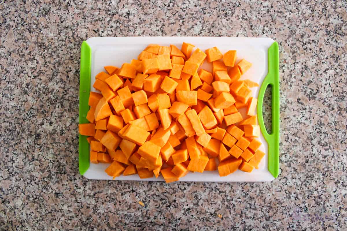 Cubed sweet potatoes on a cutting board.