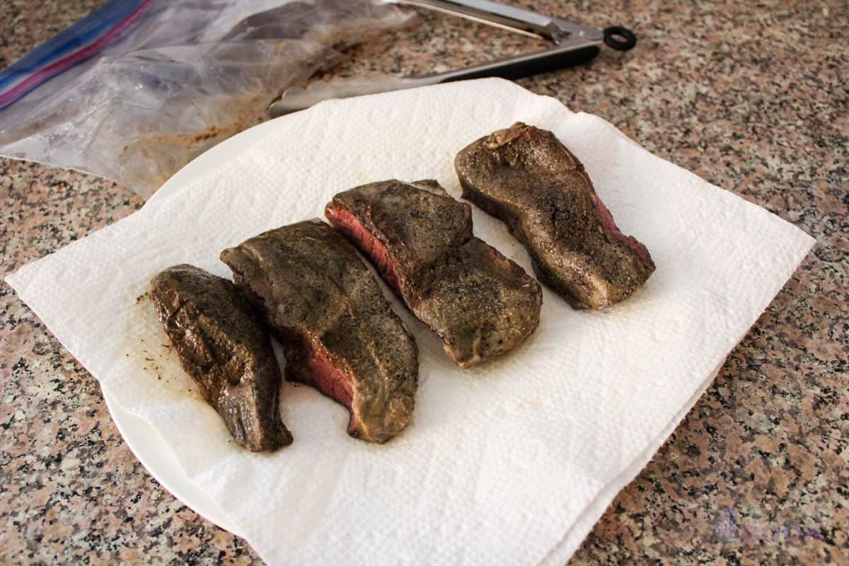 4 boneless short ribs drying on paper towels before searing.