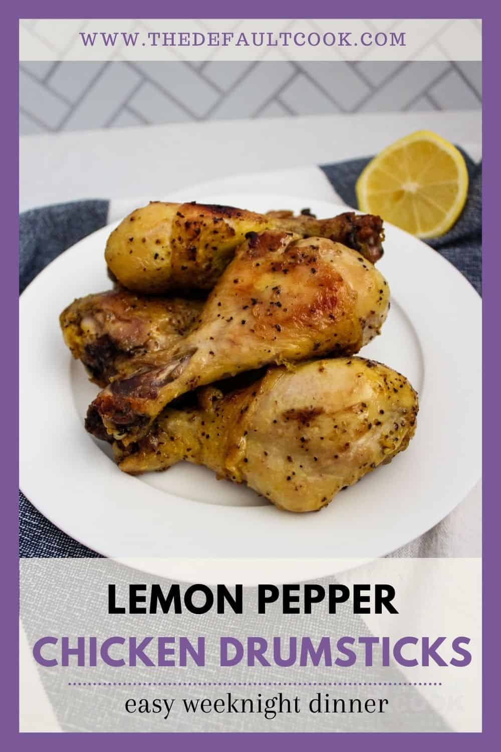Lemon pepper drumsticks on a white plate with a cut lemon behind them.
