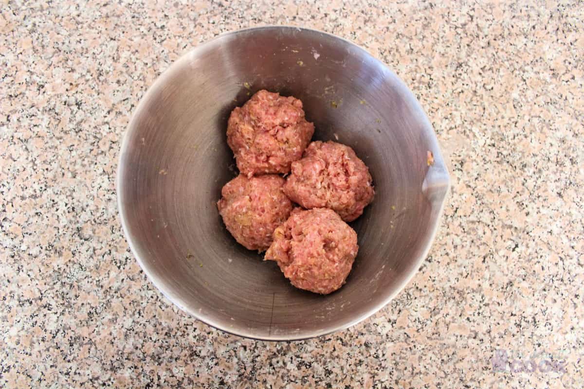 Meatball mixture after it has been divided into quarters.