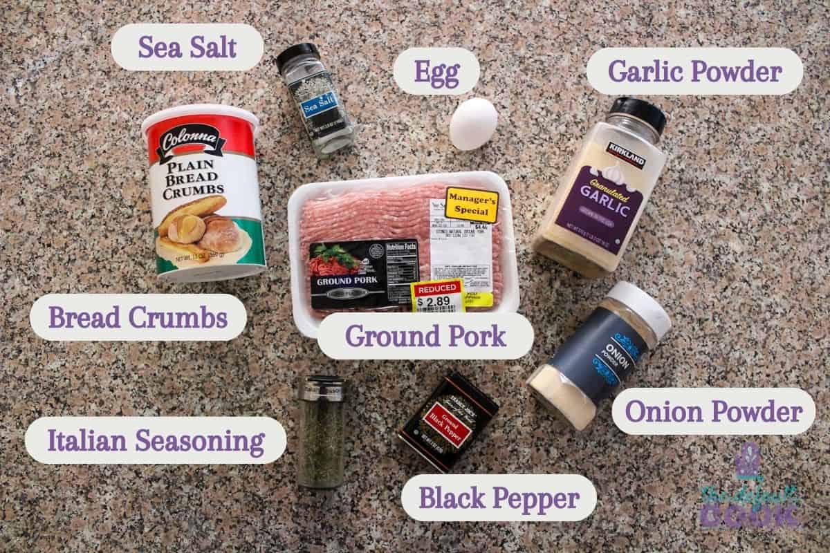 Ingredients on a kitchen counter, overlayed with text labels: bread crumbs, salt, egg, garlic powder, onion powder, black pepper, italian seasoning, and ground pork.