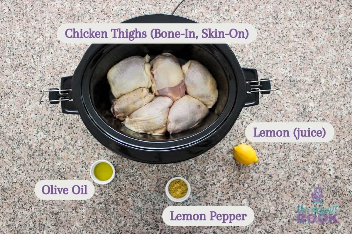 Labeled ingredients on a kitchen counter: bone-in skin-on chicken thighs, olive oil, lemon pepper seasoning, and a lemon for juice.