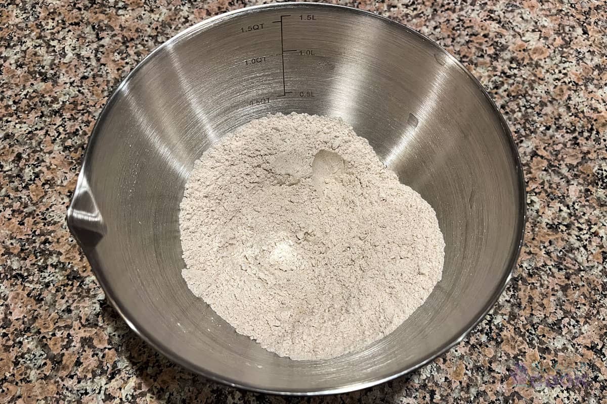 Mixed dry ingredients in a small metal bowl on a counter.