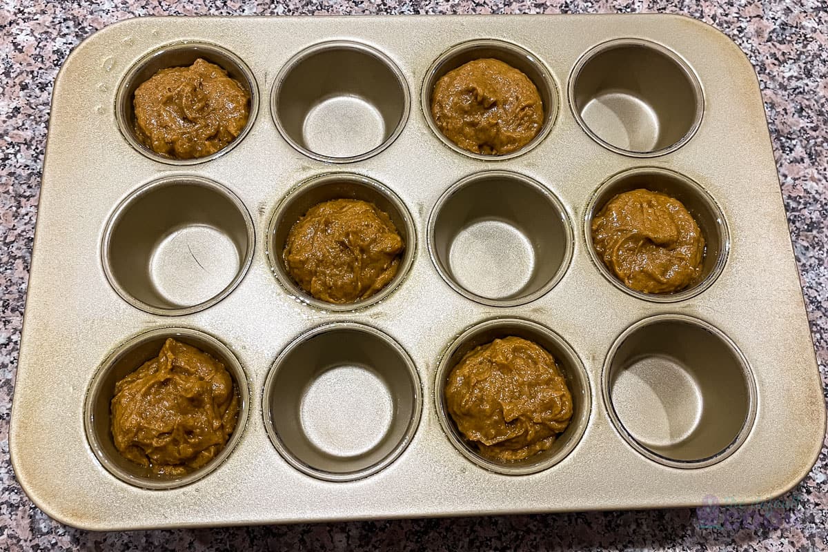 Muffin tin with 6 of the 12 muffin wells filled, with every other well filled and every other well open.