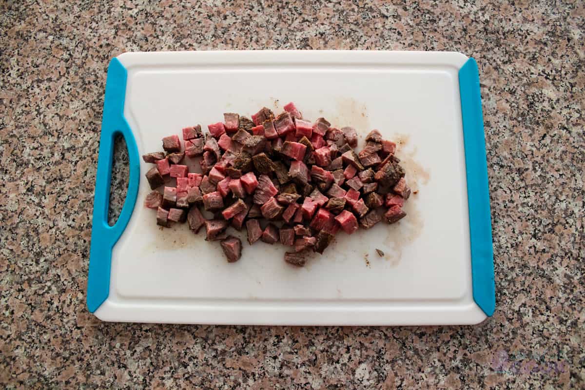 Diced cooked tri tip on a cutting board.