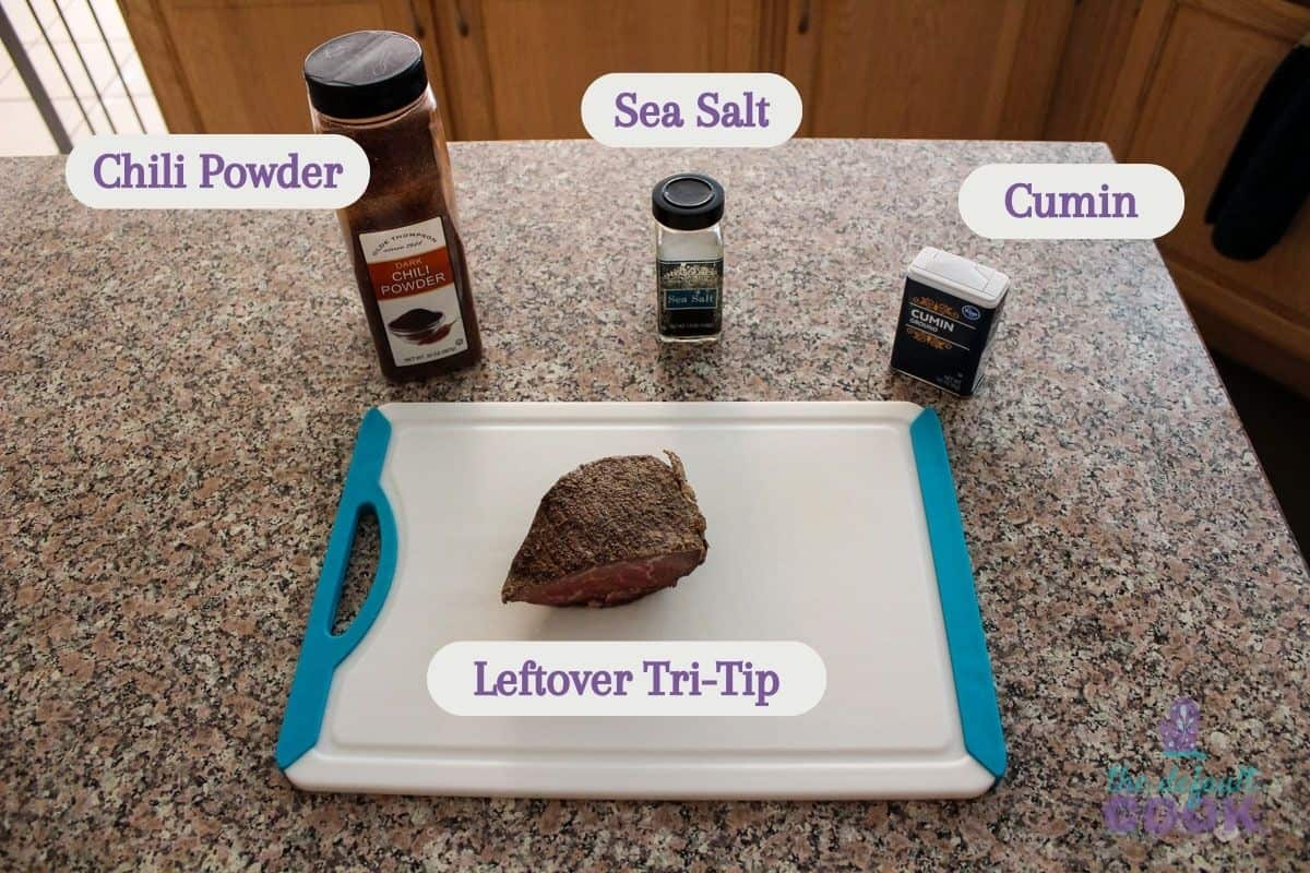 Labeled ingredients on a kitchen counter: chili powder, leftover tri tip, sea salt, and cumin.