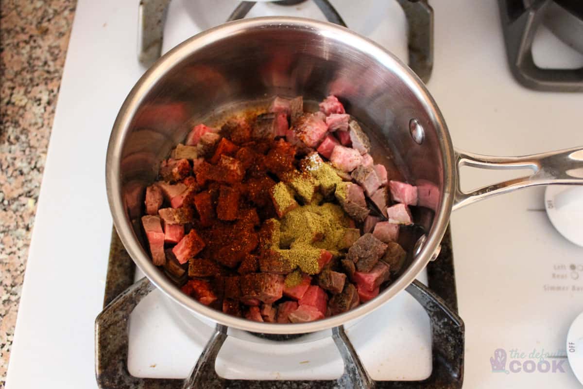Meat and spices in a small saucepan.