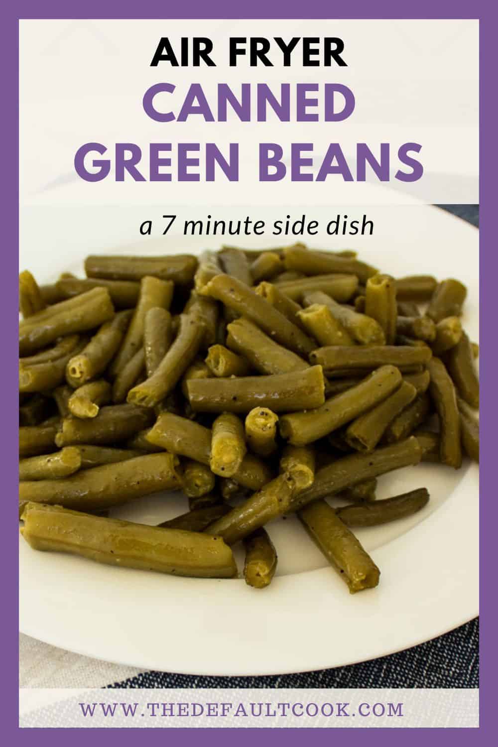 Cooked, seasoned green beans on a white plate with the name written above them.