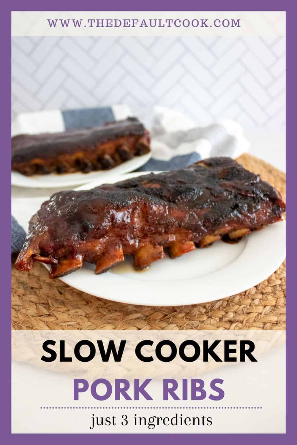 A white plate with glazed pork ribs sits on a woven mat, with another plate of ribs in the background. Text on the image reads: Slow Cooker Pork Ribs – just 3 ingredients – thedefaultcook.com.