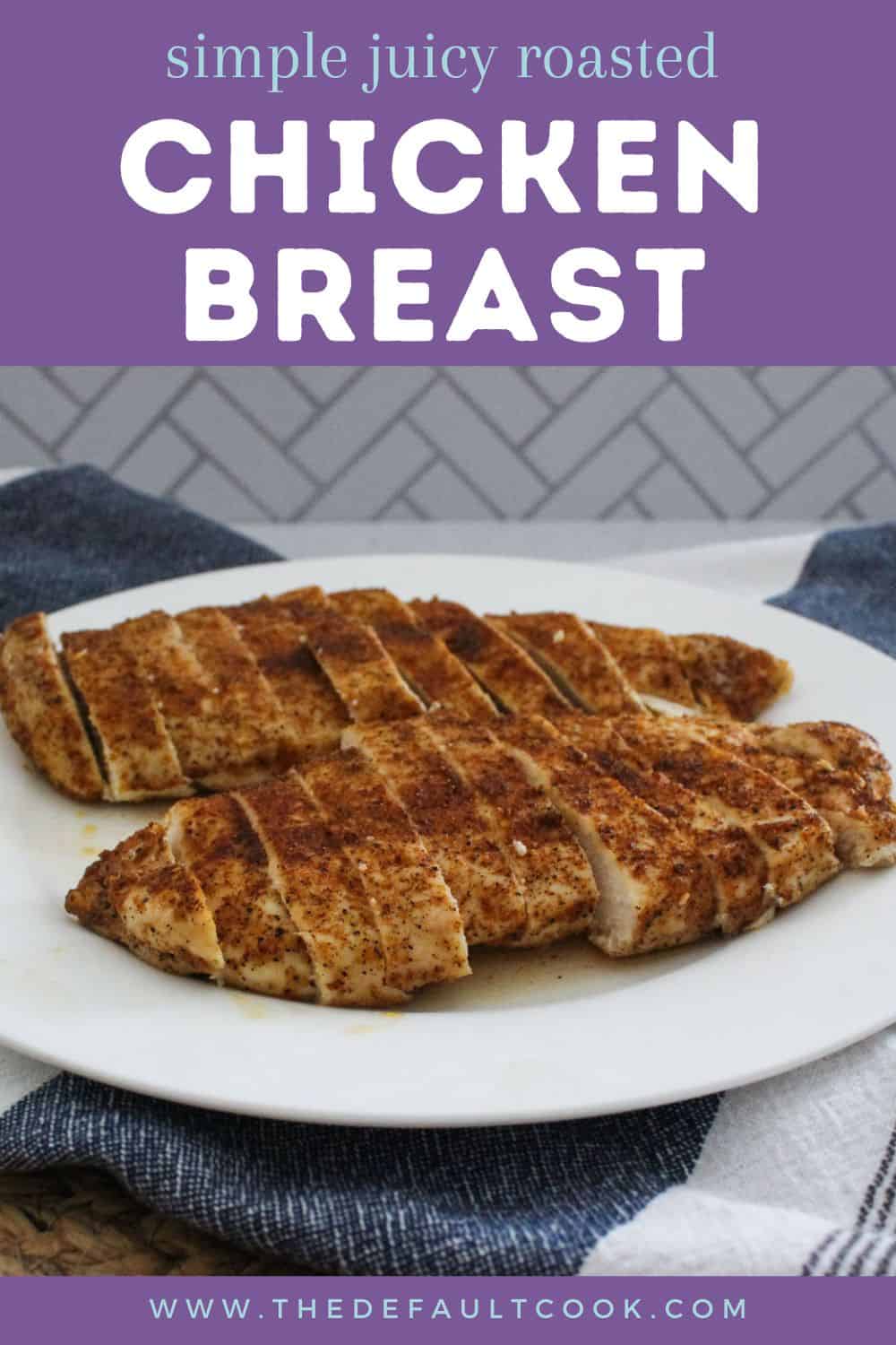 A white plate with sliced, seasoned, oven baked chicken breast sits on a blue cloth. The text above reads “Simple Juicy Roasted Chicken Breast.” The website thedefaultcook.com is visible at the bottom.