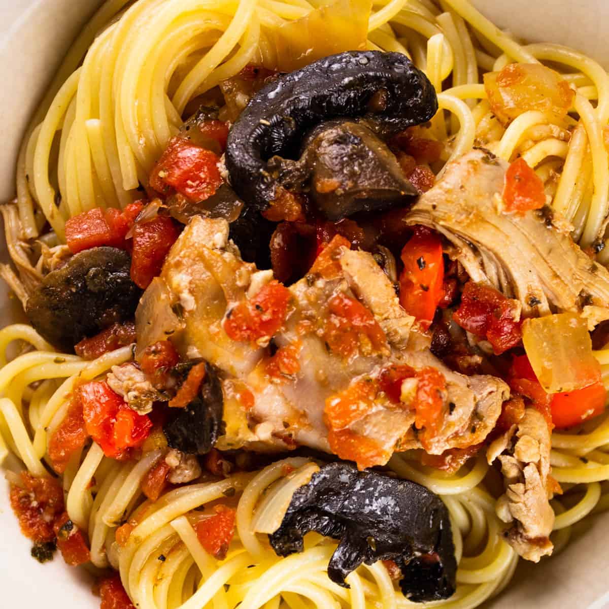 Spaghetti topped with tomato sauce, mushrooms, bell peppers, diced tomatoes, and onions.